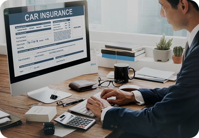 Person working at computer with insurance documents